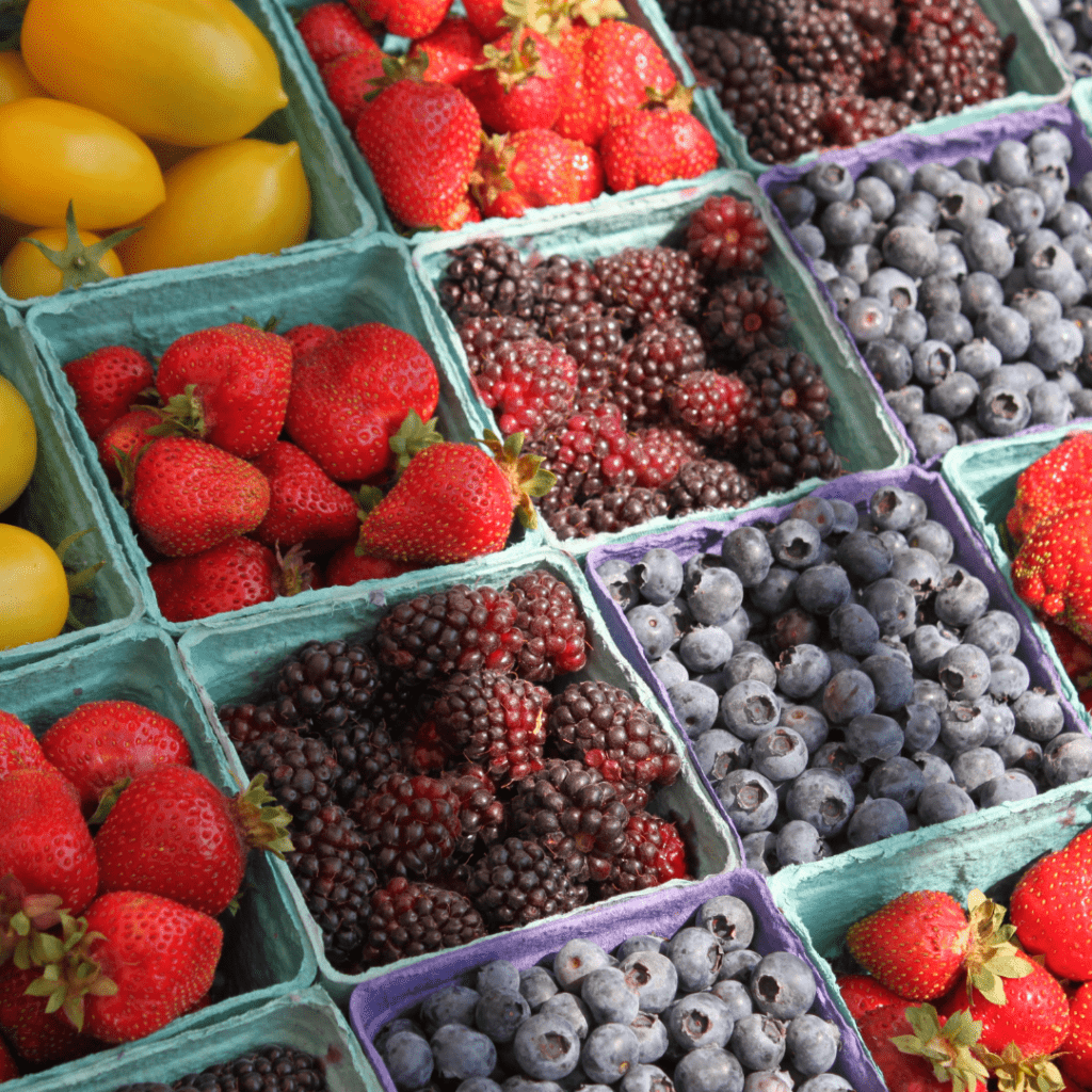 Nahaufnahme Marktstand mit frischen Erdbeeren, Himbeeren und Heidelbeeren